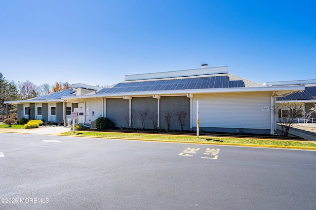 view of front facade featuring solar panels