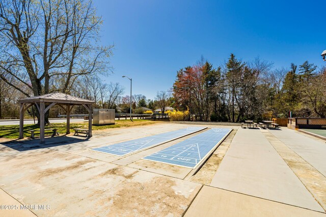 view of property's community with a gazebo and shuffleboard