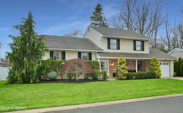 tri-level home featuring a front yard, brick siding, a garage, and concrete driveway