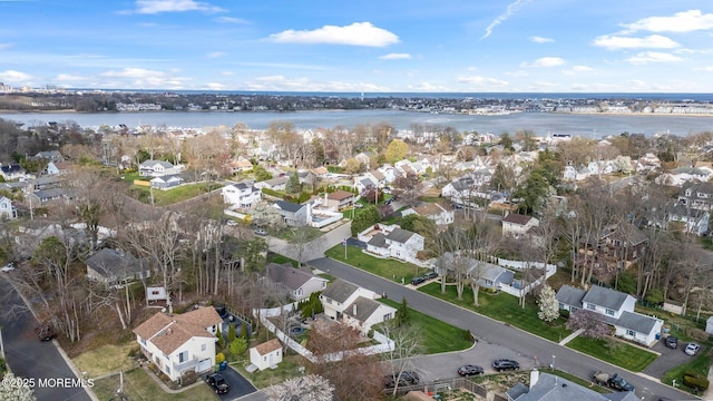 drone / aerial view featuring a residential view and a water view