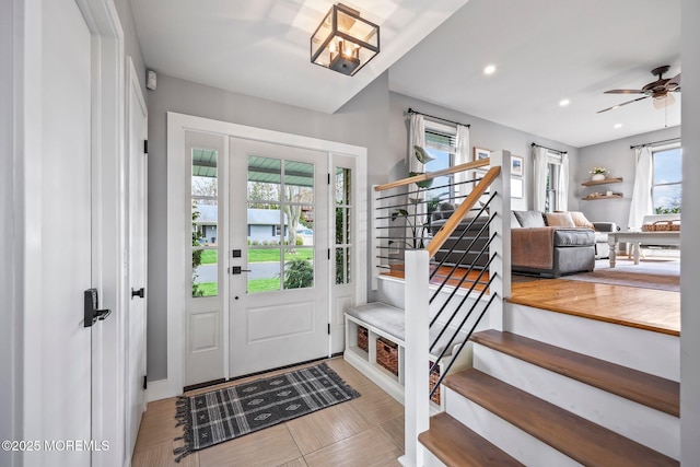 foyer with recessed lighting, stairway, a healthy amount of sunlight, and a ceiling fan