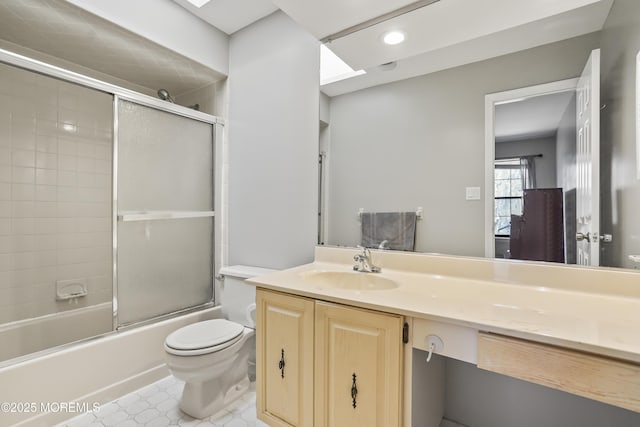 bathroom with toilet, recessed lighting, vanity, and shower / bath combination with glass door