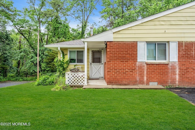 4 Flamingo Ter Unit A, Manchester, NJ 08759 - view of front facade featuring a front lawn and brick siding