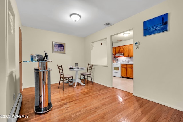 4 Flamingo Ter Unit A, Manchester, NJ 08759 - dining area featuring a baseboard radiator and light wood-type flooring