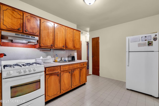 4 Flamingo Ter Unit A, Manchester, NJ 08759 - kitchen featuring white appliances, under cabinet range hood, light countertops, and brown cabinetry