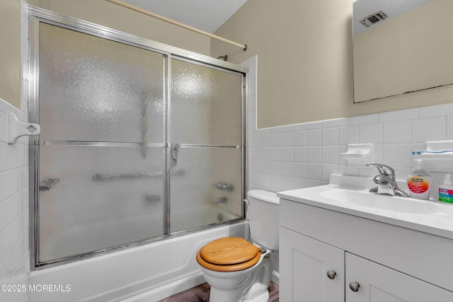 4 Flamingo Ter Unit A, Manchester, NJ 08759 - bathroom featuring tile walls, vanity, enclosed tub / shower combo, and a wainscoted wall