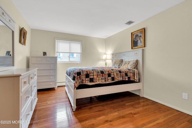 4 Flamingo Ter Unit A, Manchester, NJ 08759 - bedroom with wood-type flooring and a baseboard heating unit