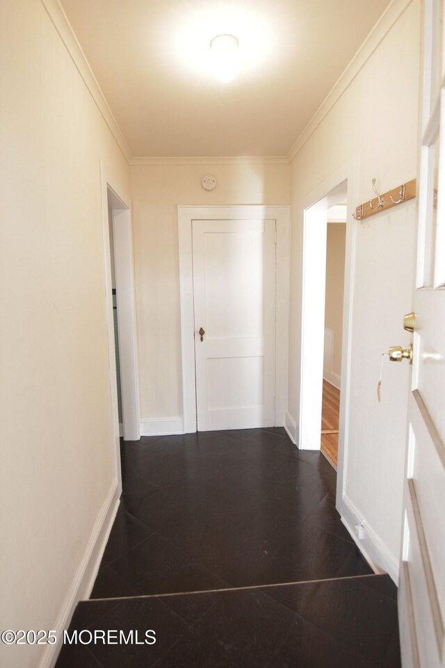 corridor with baseboards and ornamental molding