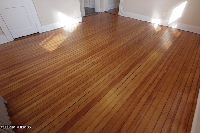 interior space featuring baseboards and wood finished floors