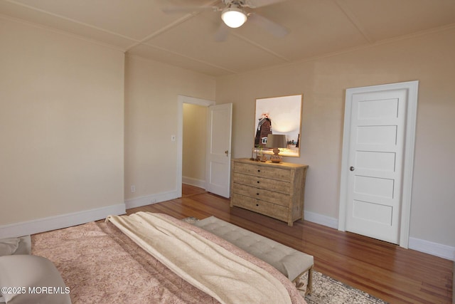 bedroom featuring baseboards, ornamental molding, ceiling fan, and wood finished floors