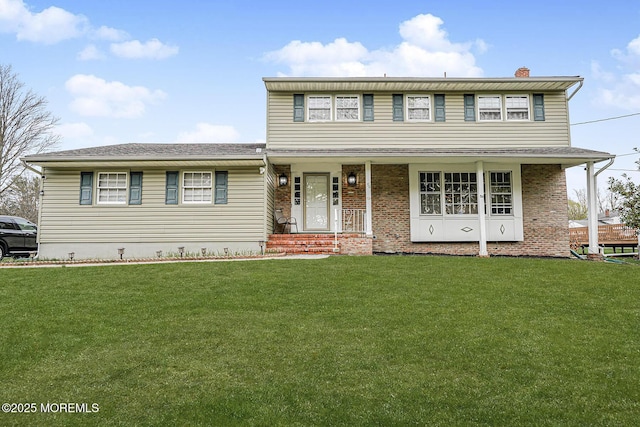 56 Dutch Rd, East Brunswick, NJ 08816 - traditional-style house featuring a front yard, brick siding, and a chimney