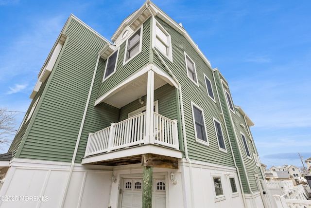 exterior space featuring a garage and a balcony