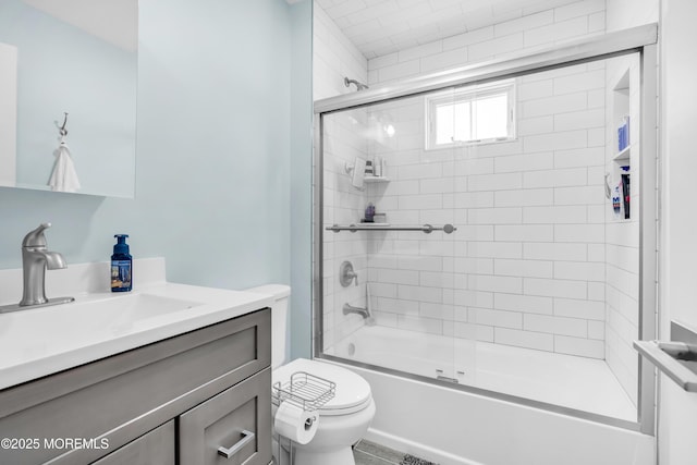 full bathroom with vanity, toilet, and bath / shower combo with glass door