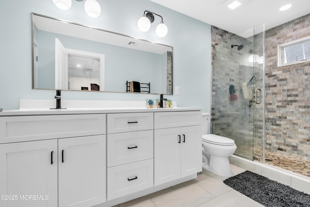full bathroom featuring a sink, a stall shower, double vanity, toilet, and tile patterned flooring