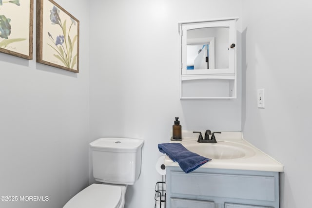 bathroom featuring toilet and vanity