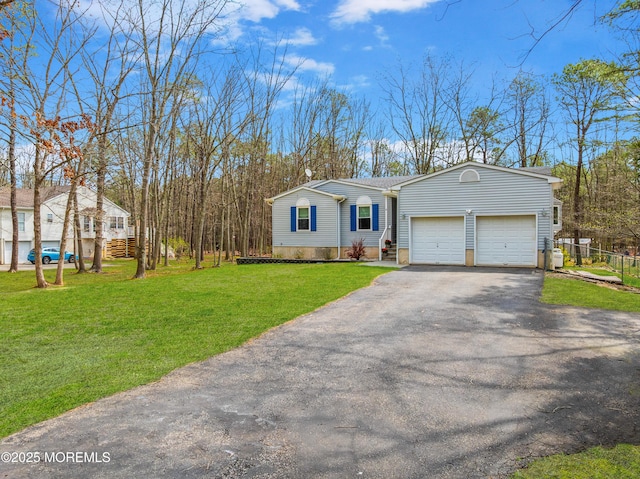 single story home with an attached garage, driveway, and a front yard