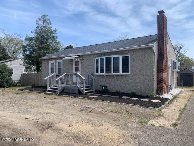 225 Admiral Ave, Beachwood, NJ 08722 - view of front of home featuring a chimney, a shingled roof, and stone siding