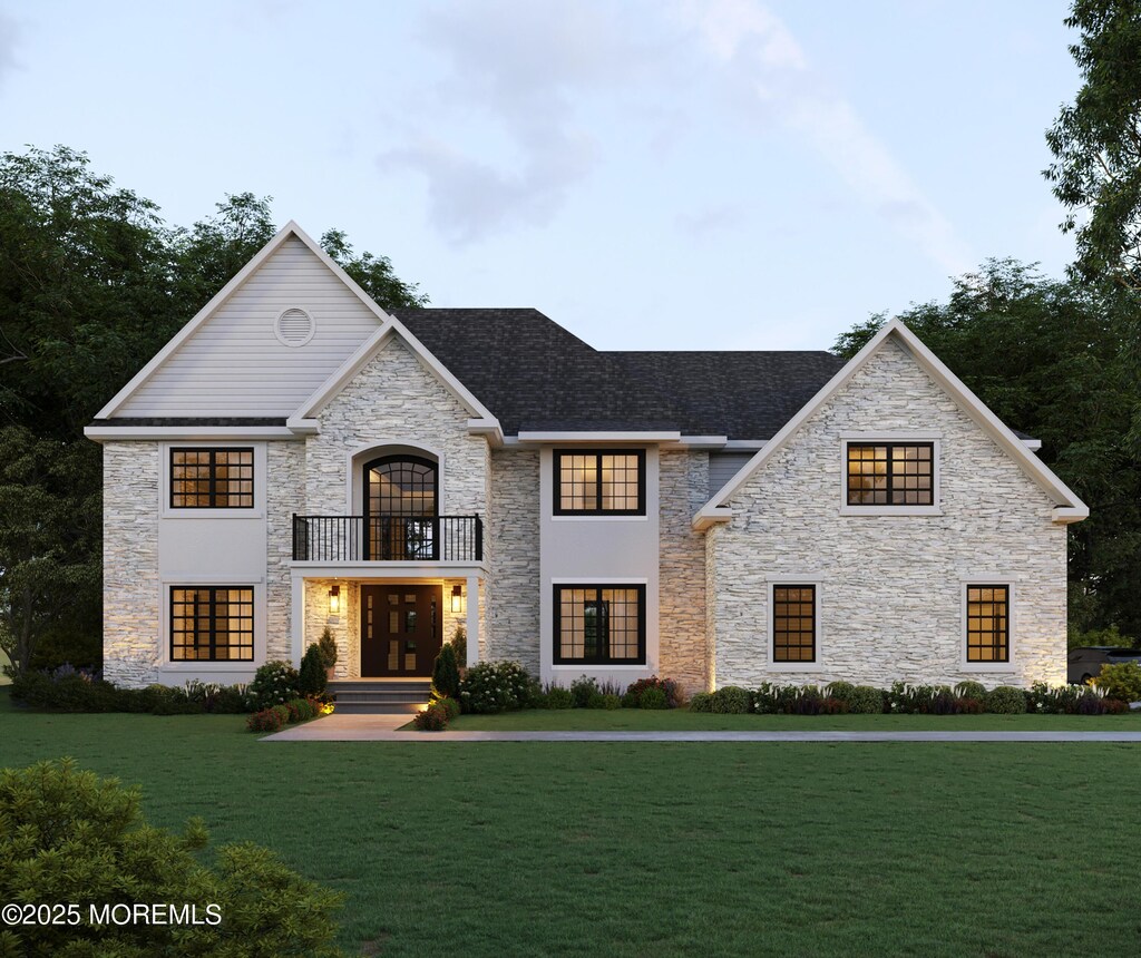 227 Monmouth Rd, Freehold, NJ 07728 - french country home featuring a front yard, a balcony, and stone siding