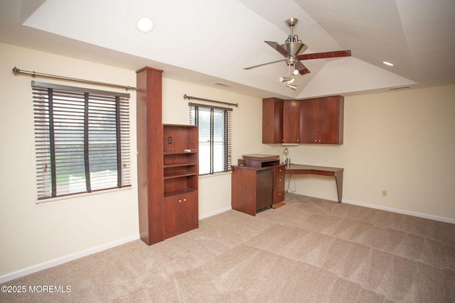 unfurnished office with visible vents, light colored carpet, baseboards, and ceiling fan