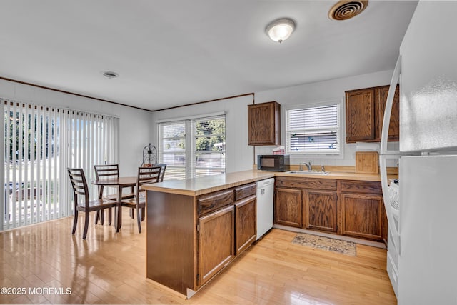 9 Banning Ct, Toms River, NJ 08757 - kitchen with light wood-style flooring, a peninsula, white appliances, and visible vents