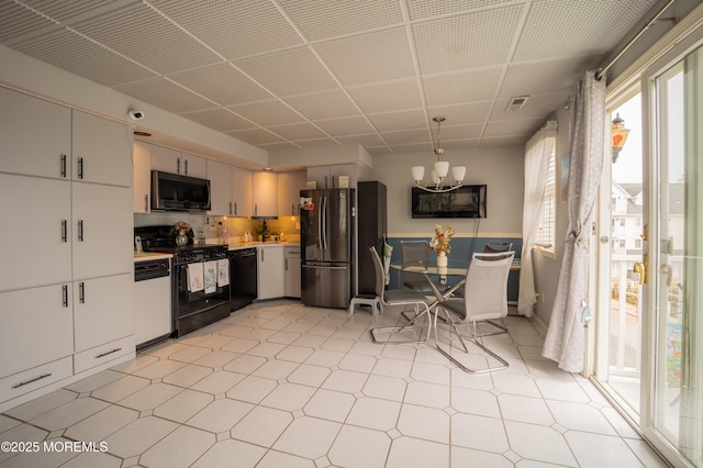 349 Harbor Vw, Forked River, NJ 08731 - kitchen featuring black appliances, light flooring, a chandelier, light countertops, and decorative backsplash