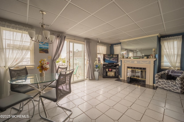 349 Harbor Vw, Forked River, NJ 08731 - dining space featuring tile patterned floors, a chandelier, a fireplace with flush hearth, and a paneled ceiling