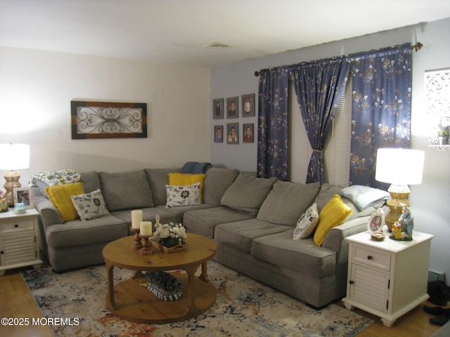 living room featuring visible vents and wood finished floors