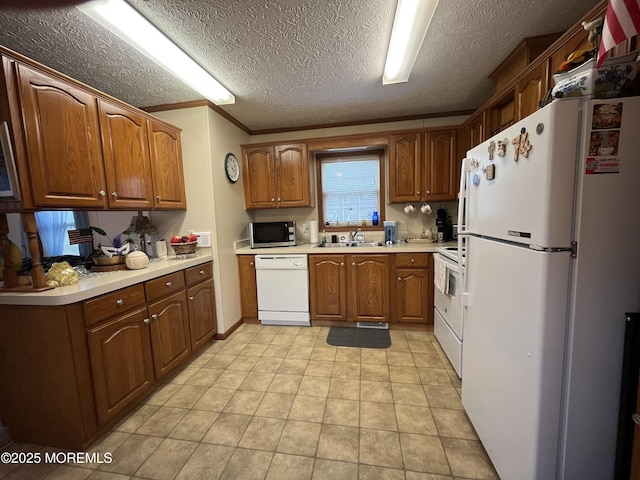 6 Raccoon Ave, Whiting, NJ 08759 - kitchen with white appliances, brown cabinets, a sink, light countertops, and a textured ceiling