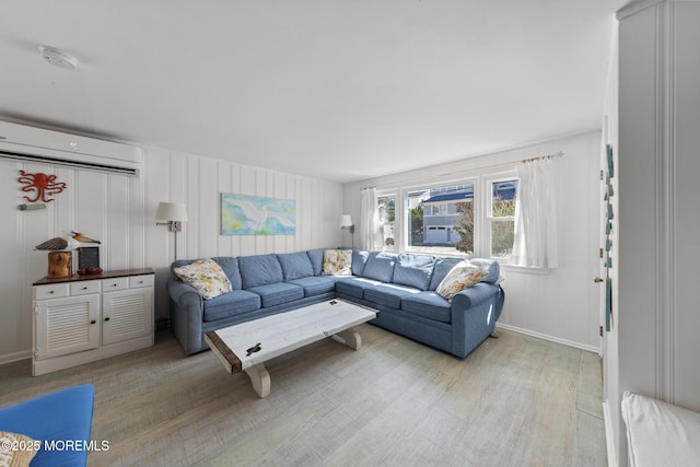 living area featuring a wall mounted AC and wood finished floors