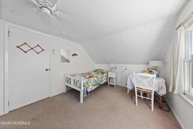 carpeted bedroom with a ceiling fan and lofted ceiling