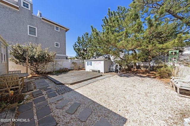 view of yard with a patio, an outbuilding, a fenced backyard, and a storage unit