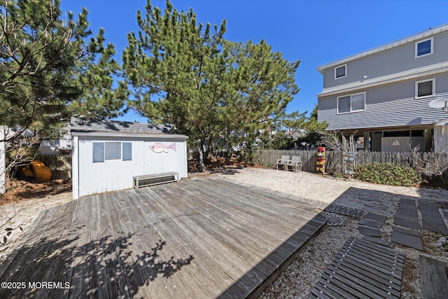wooden terrace with an outbuilding and fence