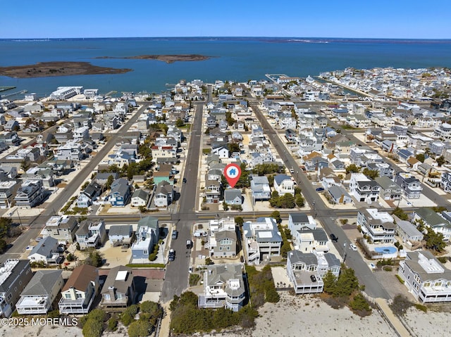 bird's eye view featuring a water view and a residential view