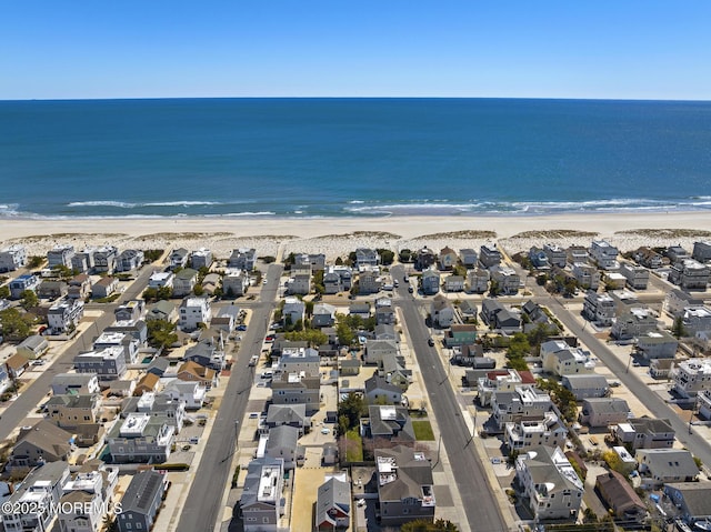 birds eye view of property featuring a water view, a residential view, and a view of the beach