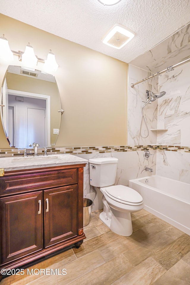 13 Gatley Close Unit 1000, Freehold, NJ 07728 - bathroom featuring visible vents, toilet, tub / shower combination, and a textured ceiling