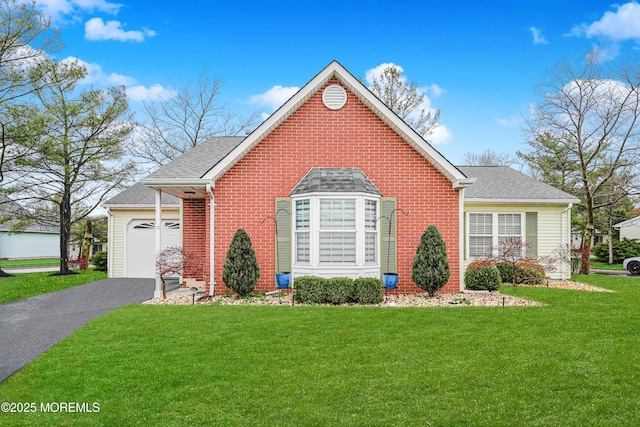 13 Gatley Close Unit 1000, Freehold, NJ 07728 - view of front of house featuring a front yard, an attached garage, brick siding, driveway, and roof with shingles