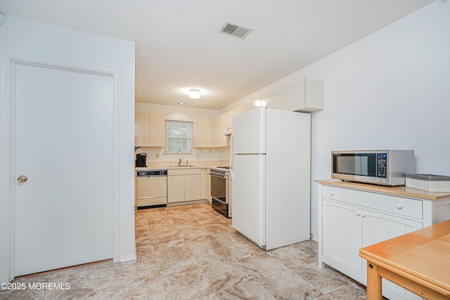 13 Gatley Close Unit 1000, Freehold, NJ 07728 - kitchen with white appliances, light countertops, a textured ceiling, visible vents, and a sink