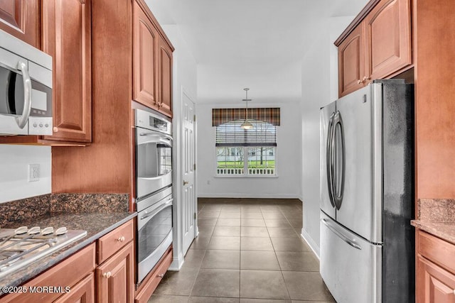 3 Marlborough Ct, Jackson, NJ 08527 - kitchen with dark stone countertops, appliances with stainless steel finishes, tile patterned floors, brown cabinets, and baseboards