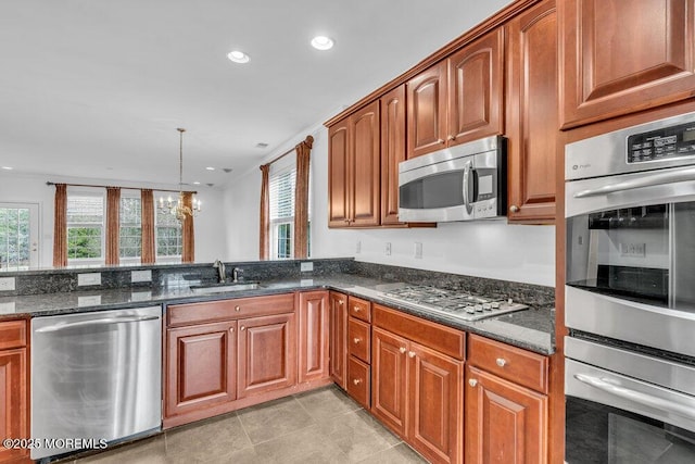3 Marlborough Ct, Jackson, NJ 08527 - kitchen featuring dark stone countertops, a healthy amount of sunlight, a sink, and stainless steel appliances