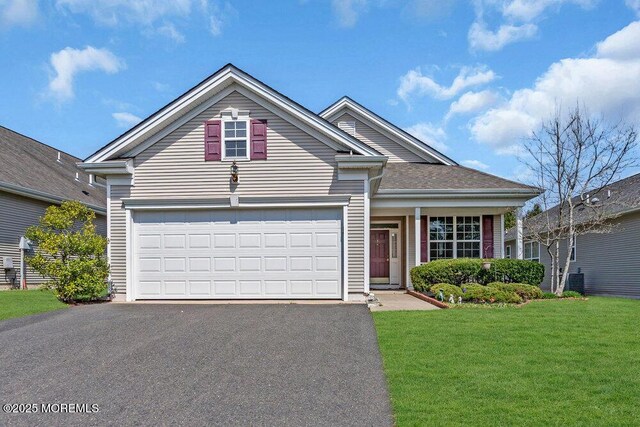 3 Marlborough Ct, Jackson, NJ 08527 - traditional home featuring a garage, aphalt driveway, and a front lawn