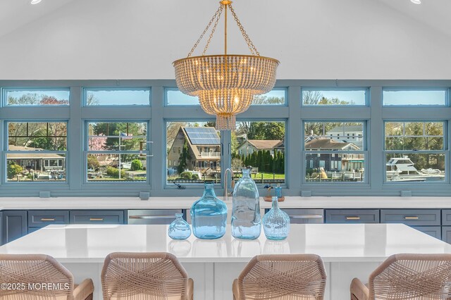1417 Holmes Ave, Toms River, NJ 08753 - dining room featuring a chandelier, vaulted ceiling, and healthy amount of natural light