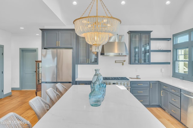 1417 Holmes Ave, Toms River, NJ 08753 - kitchen with wall chimney range hood, stainless steel appliances, a chandelier, open shelves, and glass insert cabinets