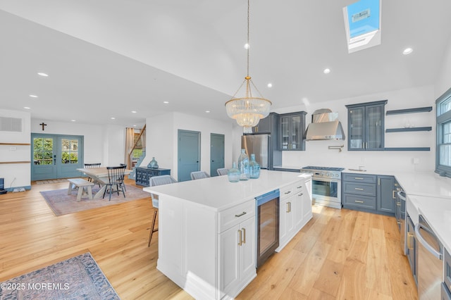 1417 Holmes Ave, Toms River, NJ 08753 - kitchen featuring wine cooler, appliances with stainless steel finishes, wall chimney range hood, light countertops, and recessed lighting