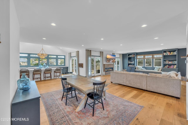 1417 Holmes Ave, Toms River, NJ 08753 - dining space with light wood-type flooring, healthy amount of natural light, recessed lighting, and a warm lit fireplace