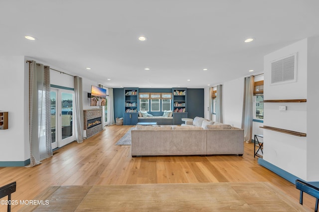 1417 Holmes Ave, Toms River, NJ 08753 - living area featuring light wood-style flooring, recessed lighting, a glass covered fireplace, and baseboards