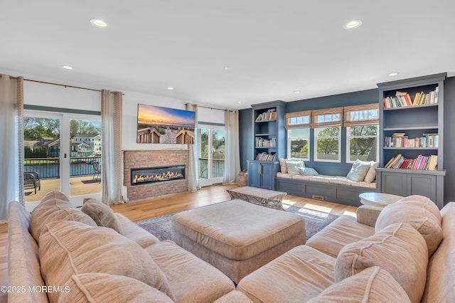 1417 Holmes Ave, Toms River, NJ 08753 - living room with recessed lighting, wood finished floors, plenty of natural light, and a glass covered fireplace