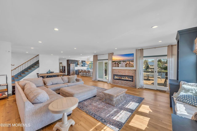 1417 Holmes Ave, Toms River, NJ 08753 - living area with stairway, recessed lighting, light wood-style floors, and a large fireplace