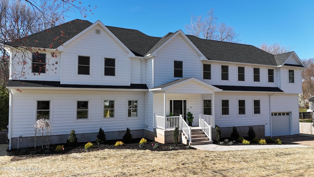 view of front of property with central AC unit and an attached garage