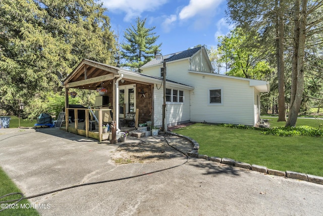 back of property featuring a yard
