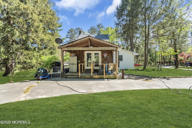 rear view of property with a yard and french doors